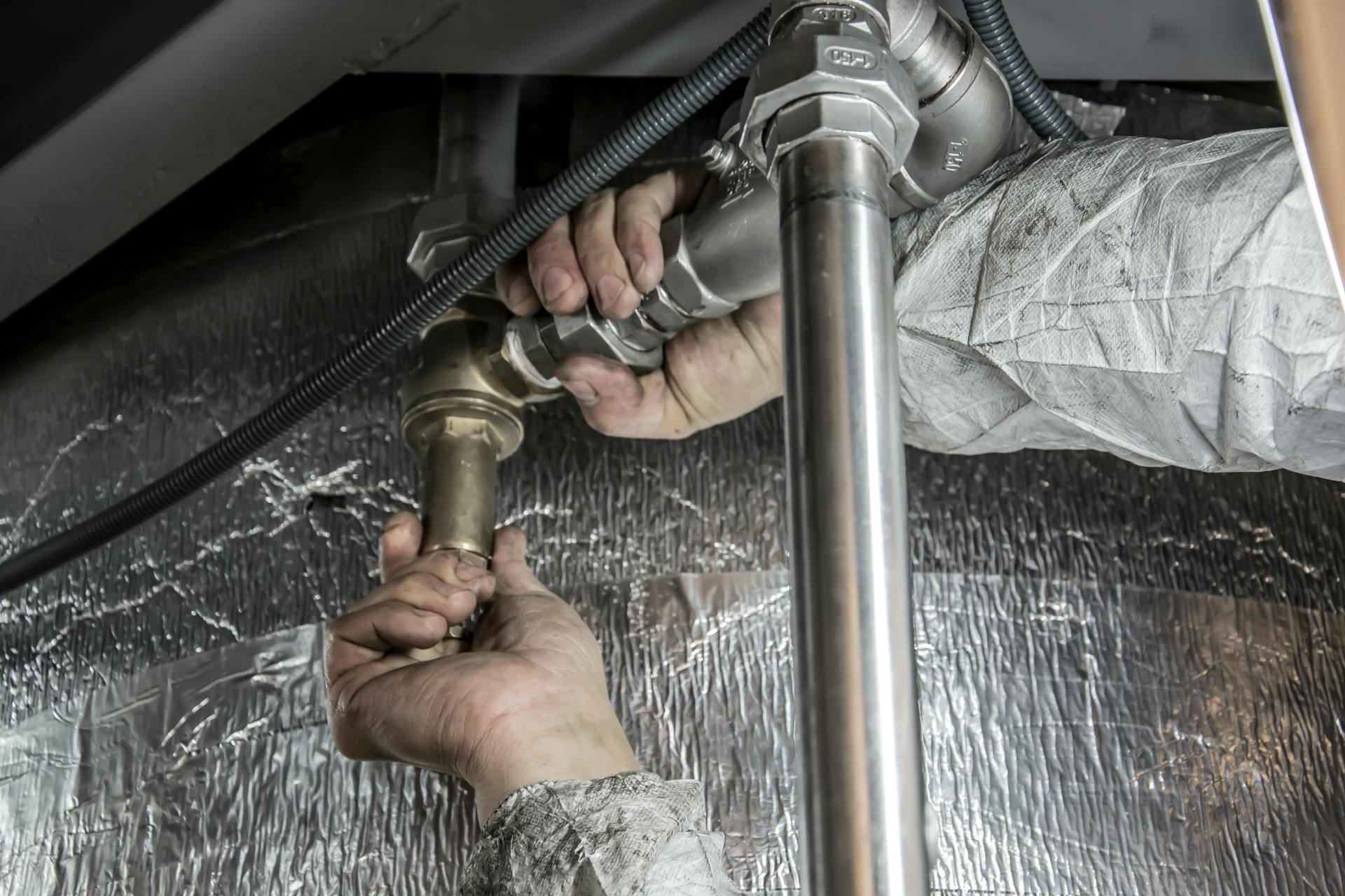 Plumber working on pipes in winter